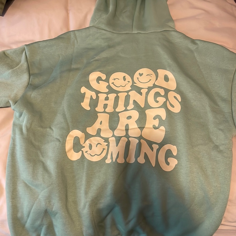 SHEIN hoodie in the color green with words on the back